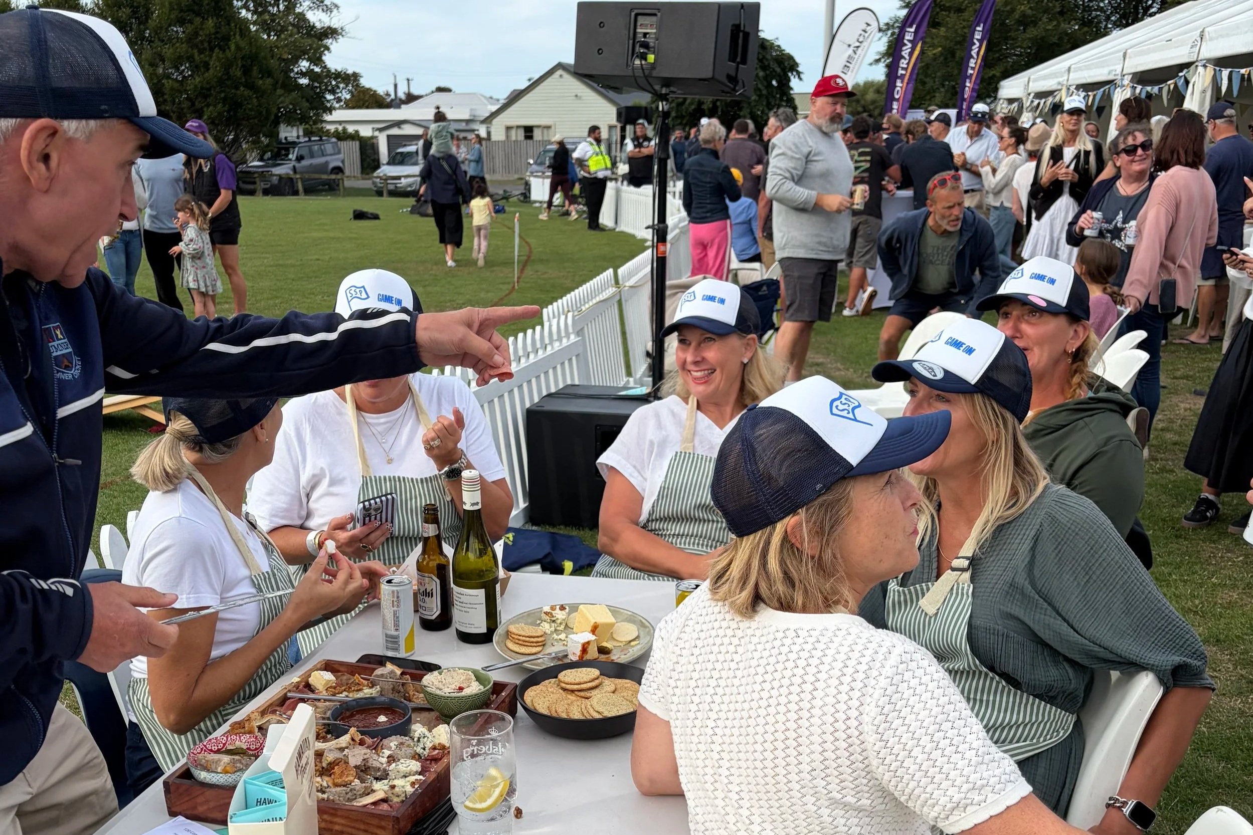 Volunteers sit around a table at a community fundraising event.