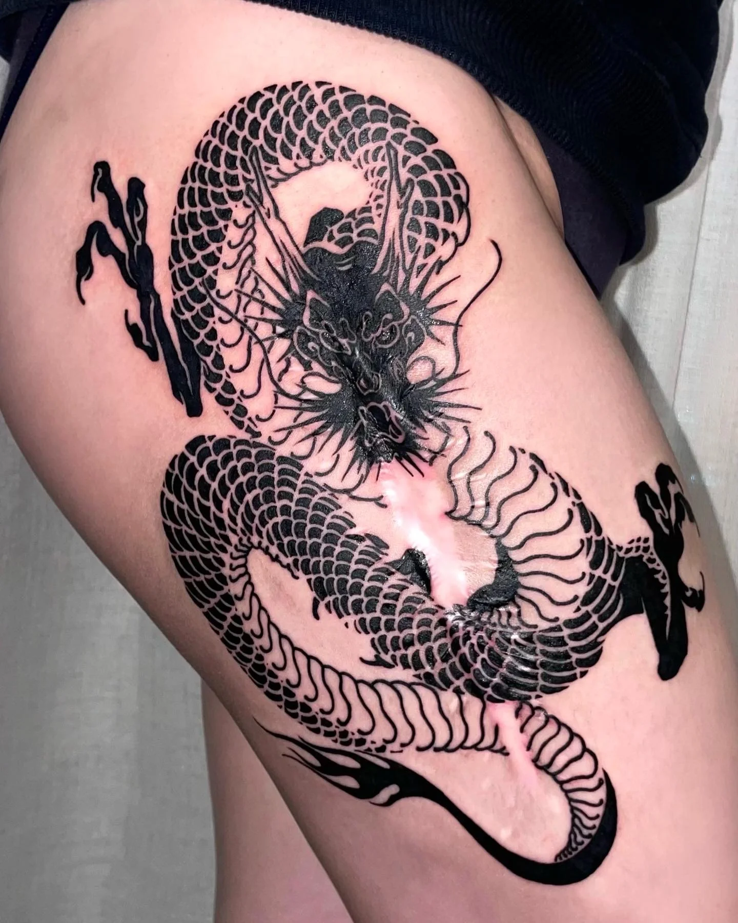 CAIN immaculate scar style Brooklyn NYC tattoo artist blackwork legs tattoo dragon scar cover tattoo