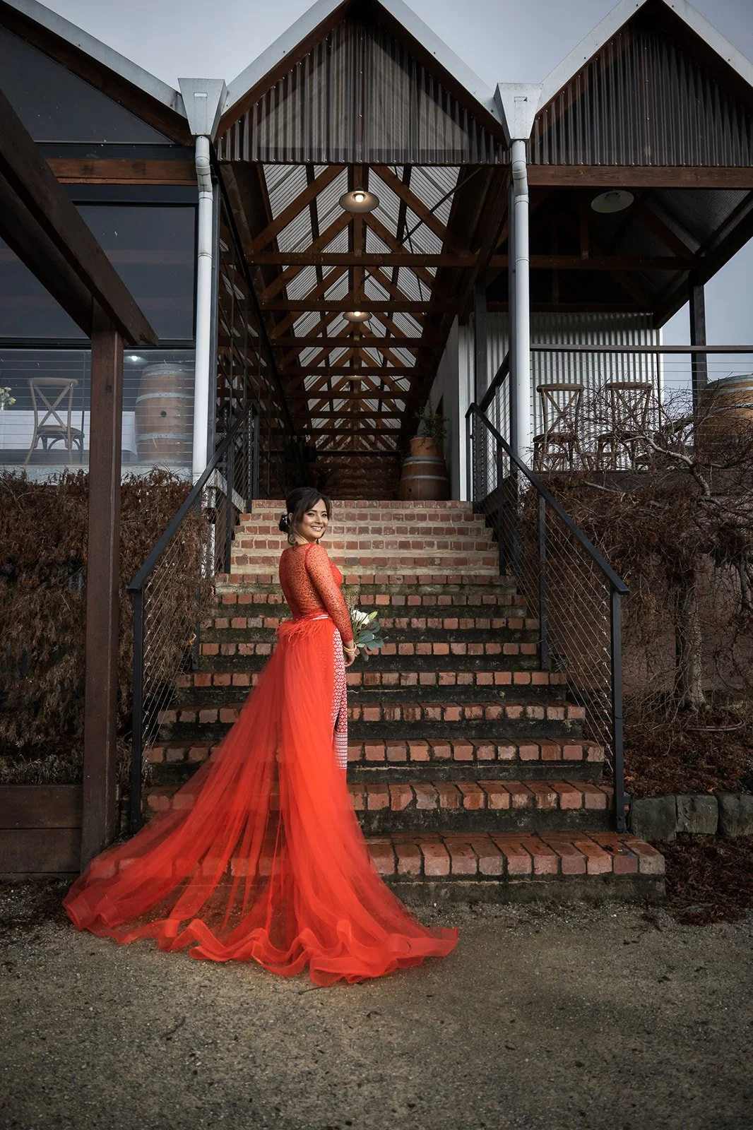 Bride in a red wedding dress on steps