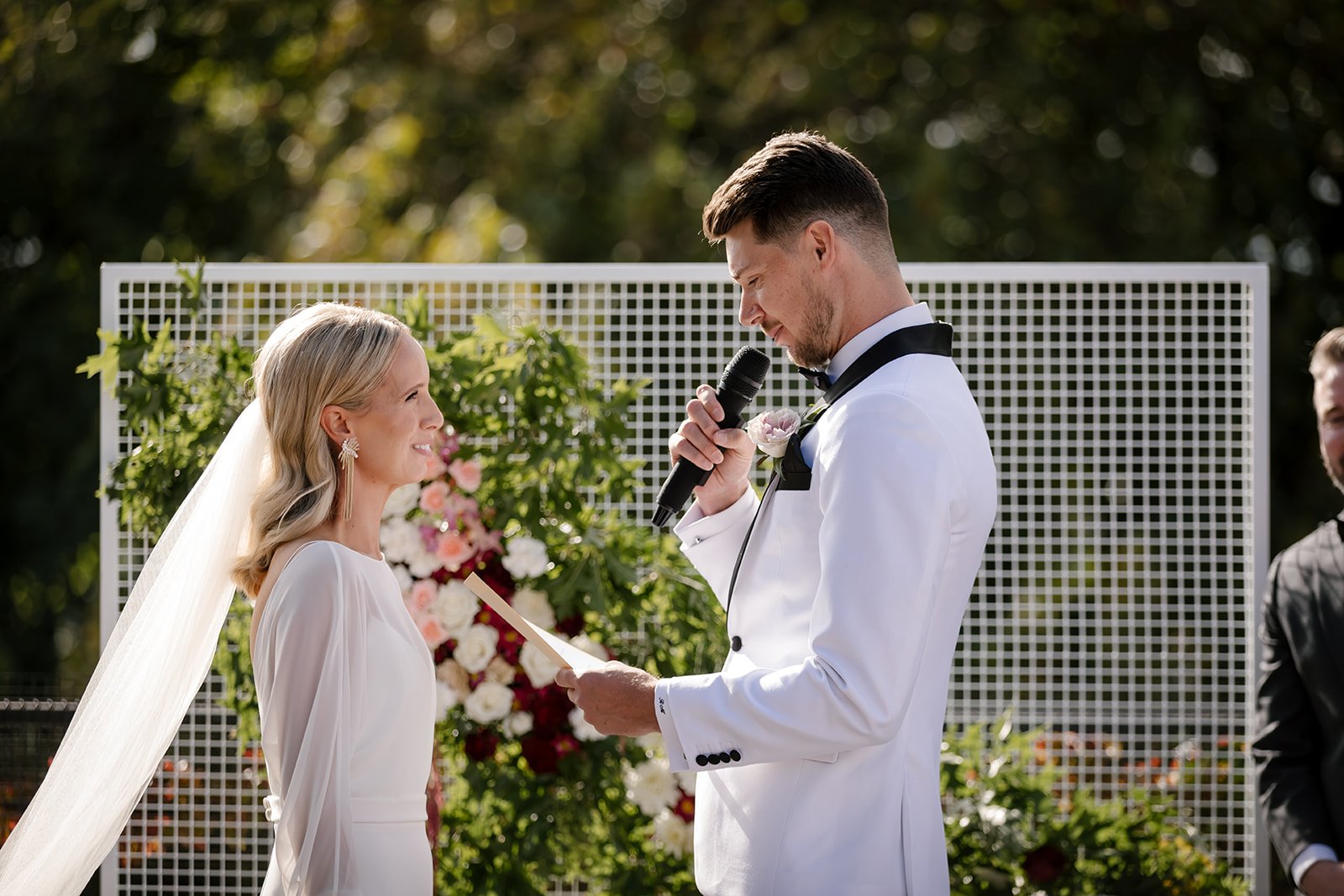 Bride and groom exchanging vows at outdoor wedding