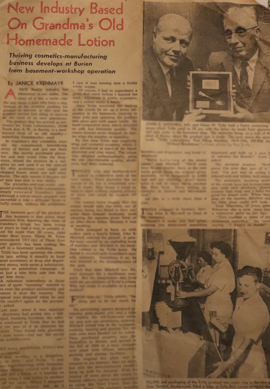 A newspaper article discussing Granny's homemade lotion, with a photo of two men holding a box with lotion jars and a spatula, and a photo of women packaging the lotion.