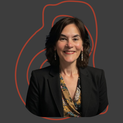 A woman with shoulder-length dark hair, wearing a black blazer and a patterned blouse, smiling in front of a dark background with red abstract line art.
