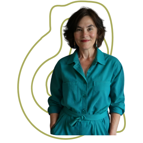 A woman with dark, curly hair wearing a teal button-up dress with rolled-up sleeves and a tie belt, smiling at the camera.