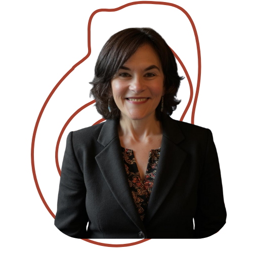 A woman with shoulder-length dark hair wearing a black blazer and a patterned blouse, smiling at the camera against a red background.