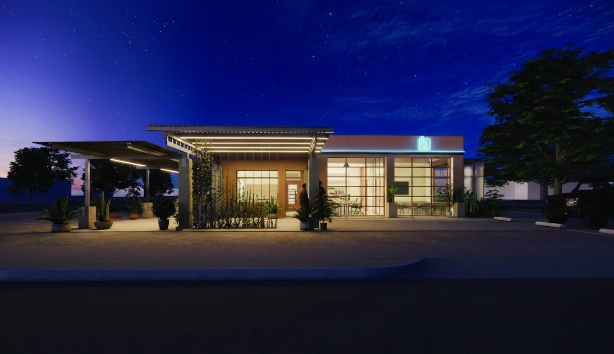 Night view of adaptive re-use project with neon signs and lighted patios