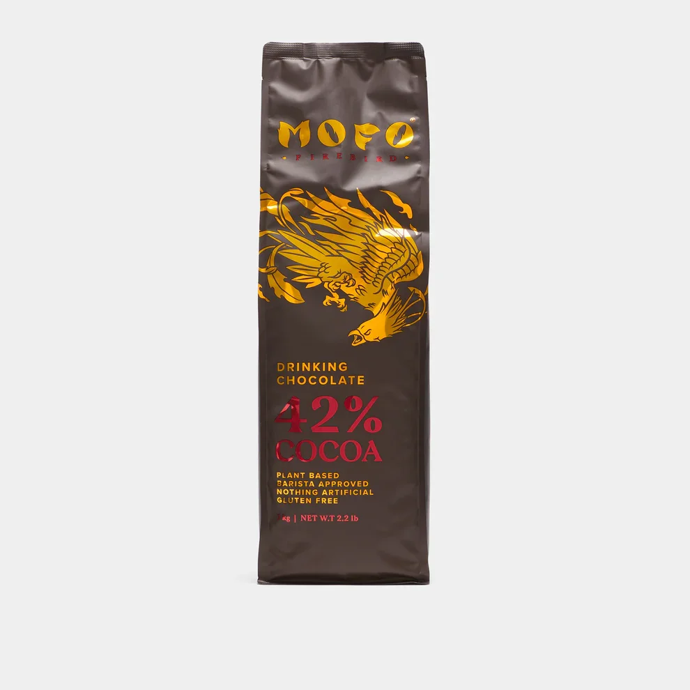 A package of MODO drinking chocolate with 42% cocoa content, featuring a gold eagle illustration on a dark brown background.