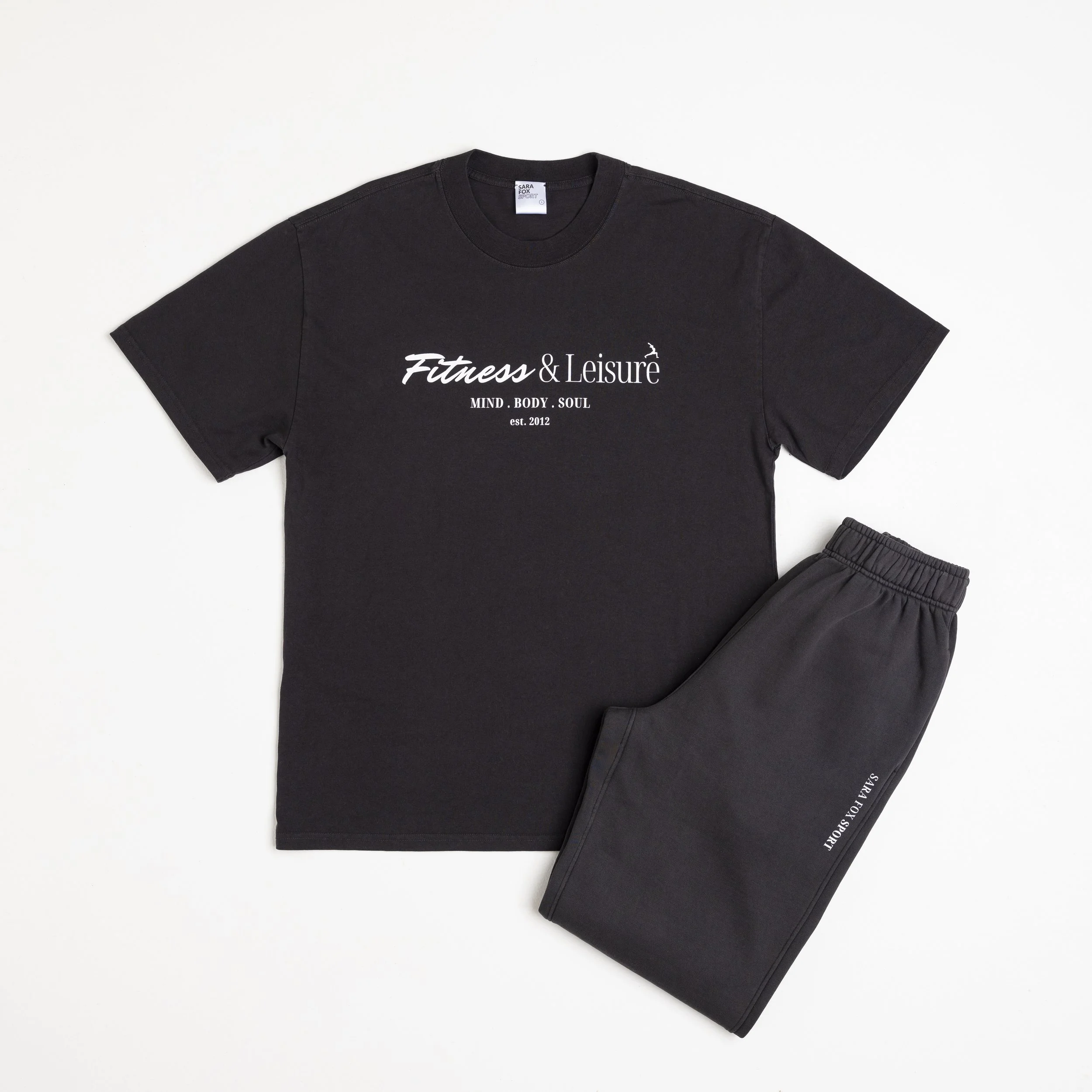 Black t-shirt and matching sweatpants set with white text and logo for Fitness & Leisure brand.