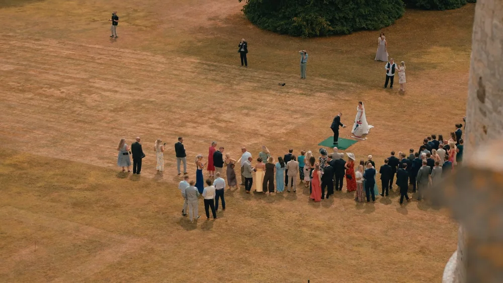Wedding guest play golf on the lawn at Lulworth Castle in Dorset 
