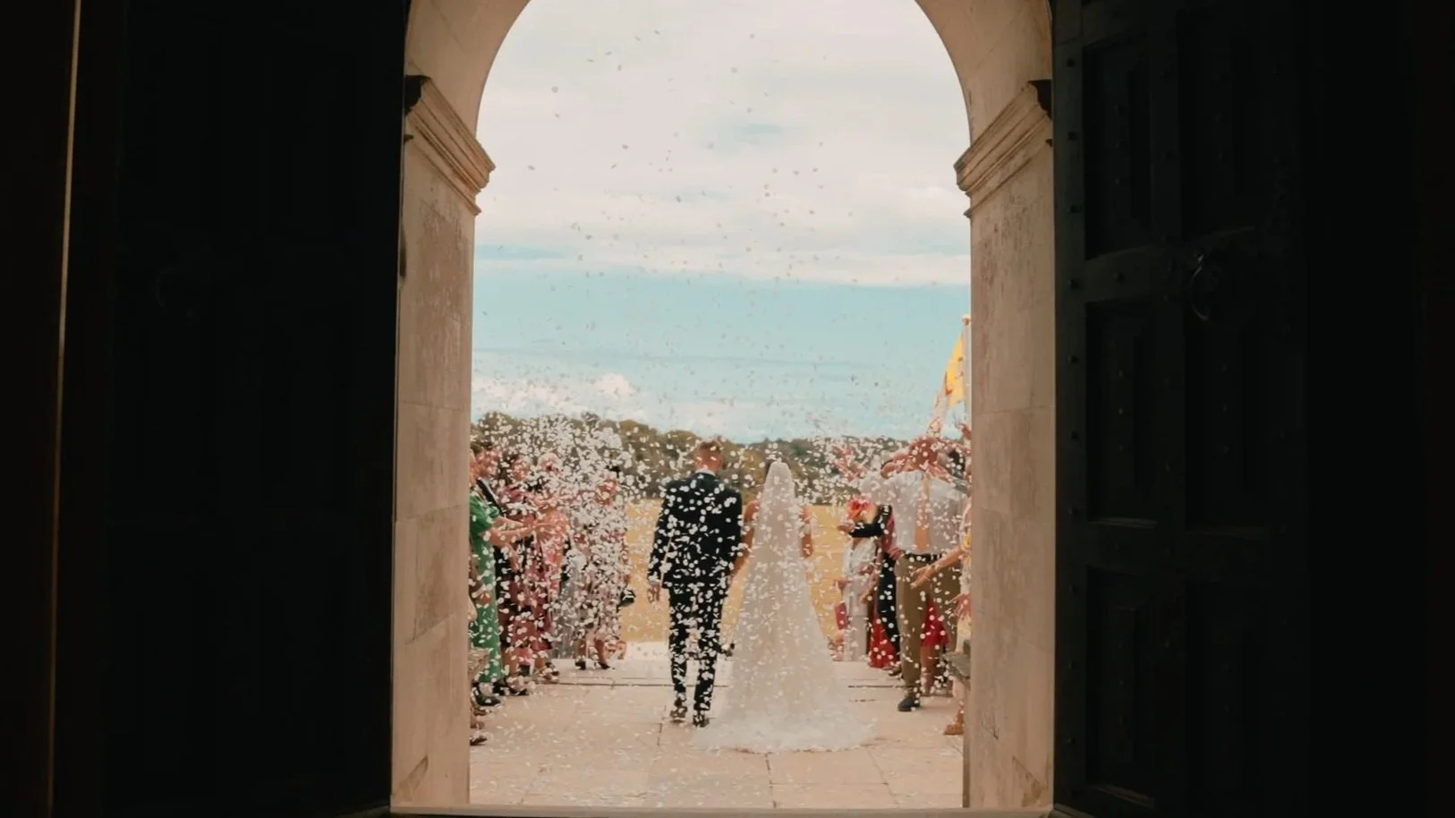 confetti after a wedding ceremony at Lulworth Castle, filmed by lulworth castle wedding videography