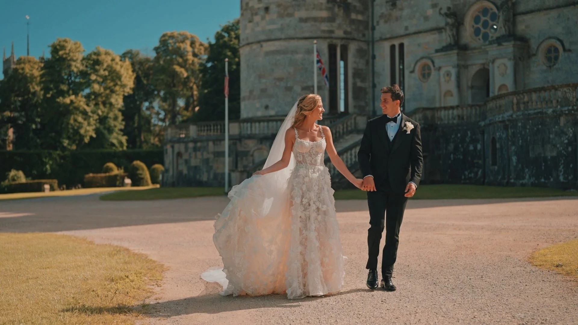 a wedding couple walking in the grounds at Lulworth Castle, filmed by Lulworth Castle Wedding videographer