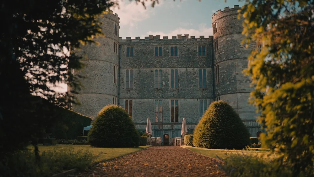 A shot of Lulworth Castle through some bushes, filmed by a videographer in Dorset 