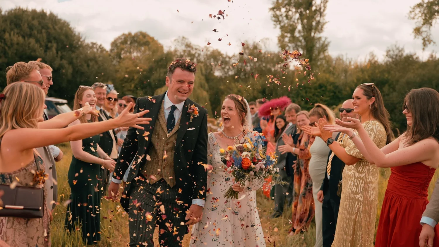 Pinglestone Barn in Hampshire - A wedding couple walks through a confetti line