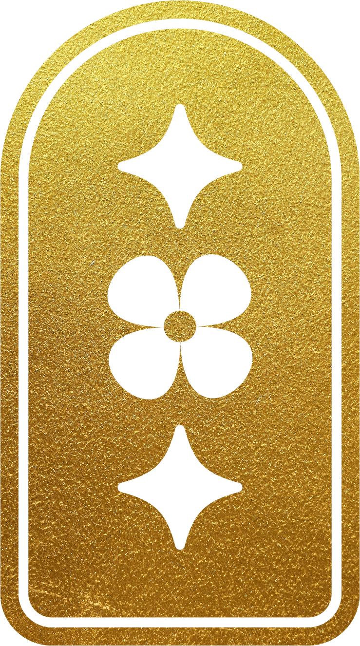 A gold surface with four cut-out symbols: a star, a circle with four petal shapes inside, an arrow pointing downward, and a horizontal line with a small vertical line beneath it.