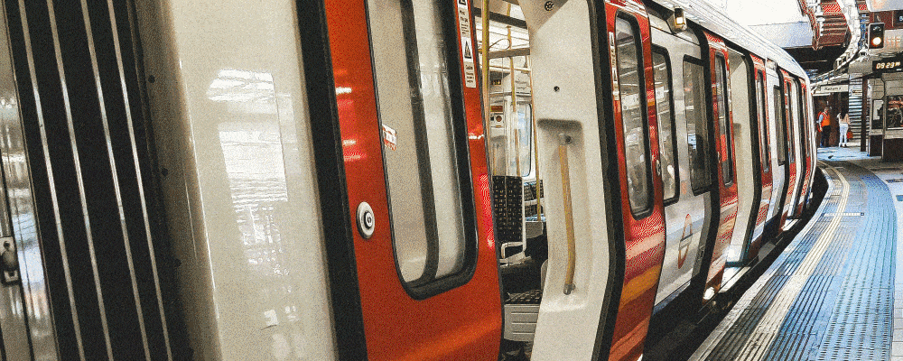 Red and white subway train at a station platform.