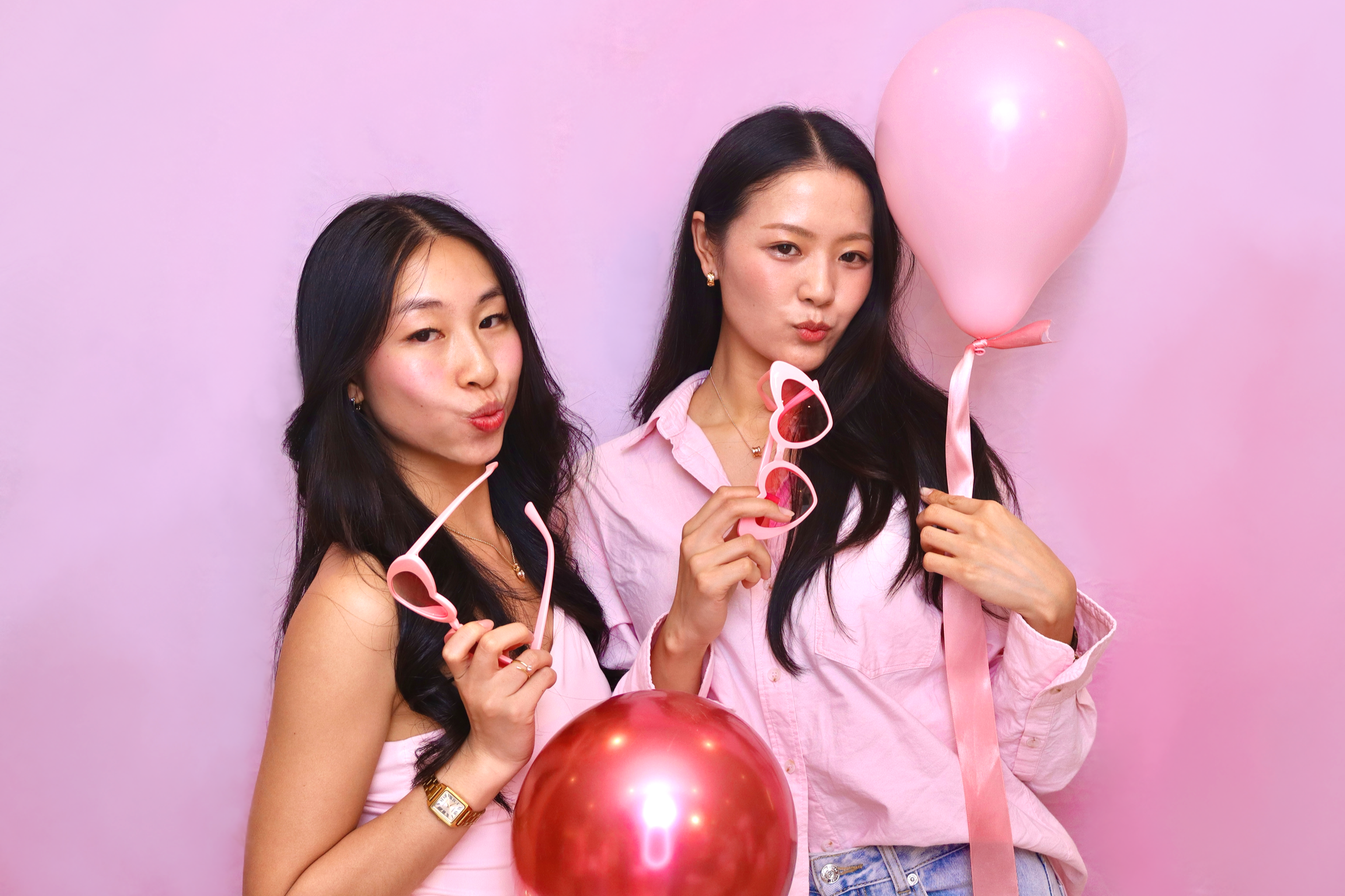 Two friends holding balloons