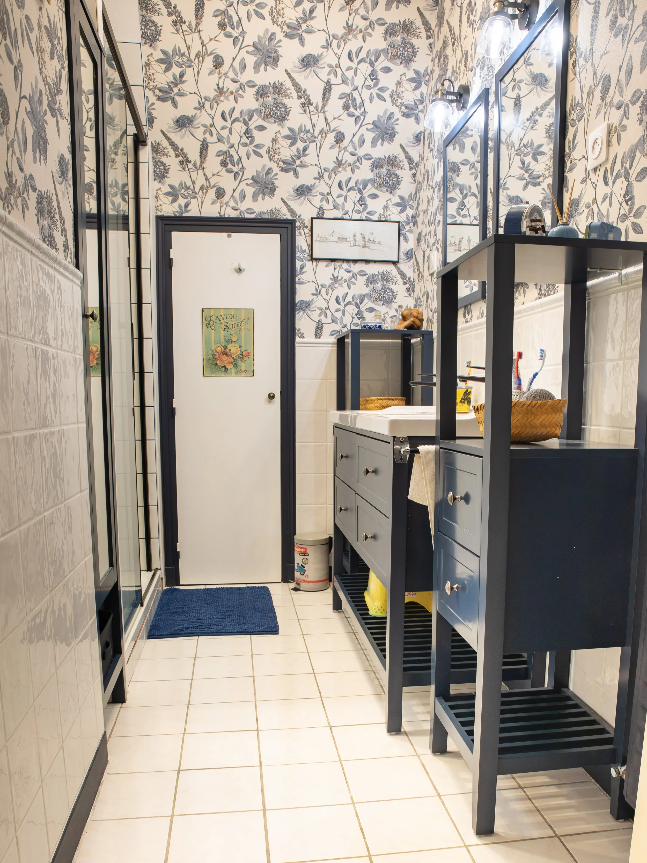 Salle de bain bleue carrelée tapisserie blanche, bleue fond fleuri