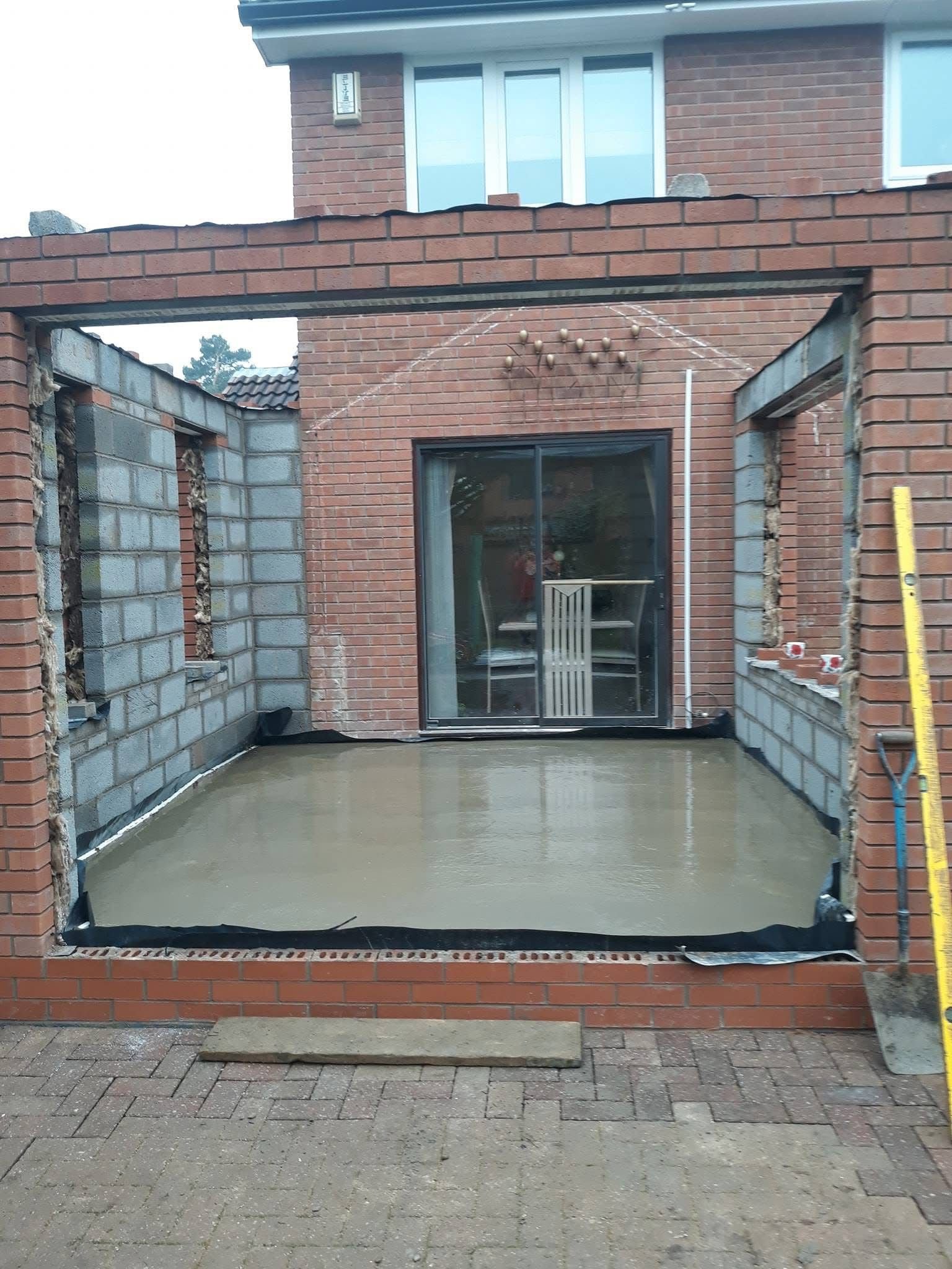 Home extension construction with brick and concrete walls