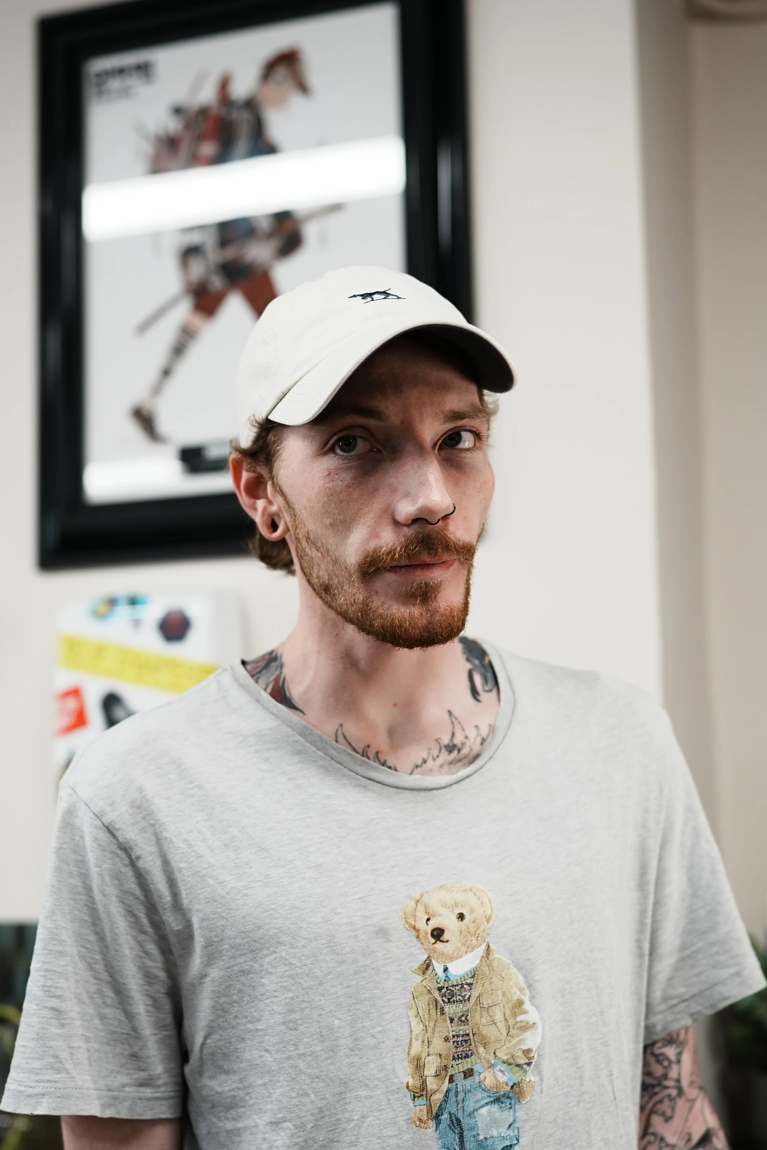 Person with medium-length wavy hair, wearing a baseball cap