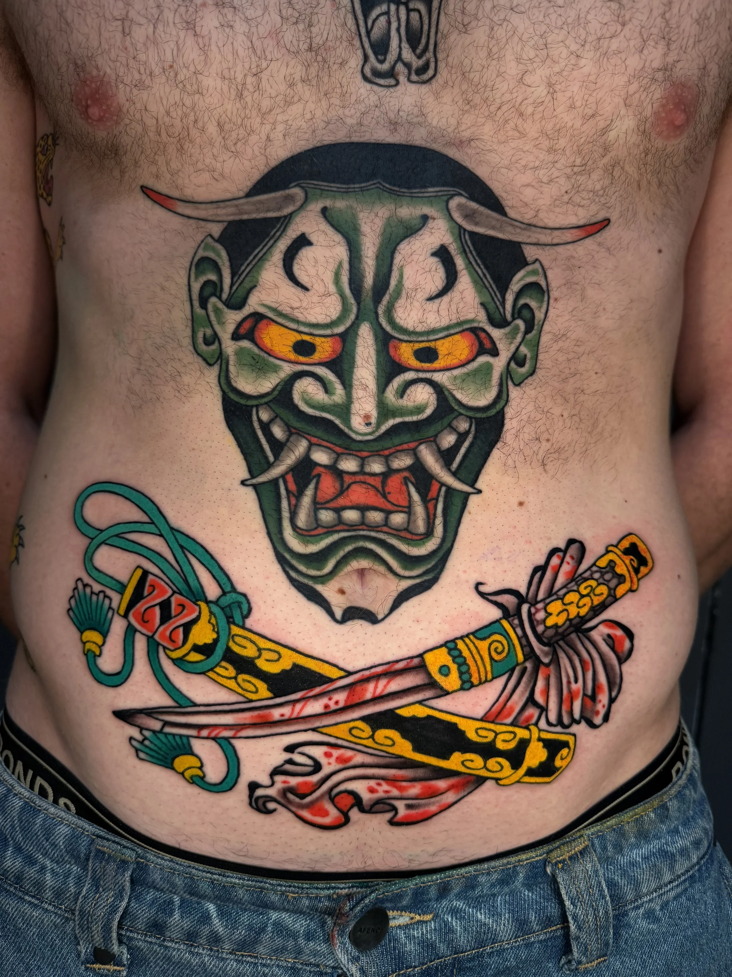 Hanya mask and swords tattoo on stomach