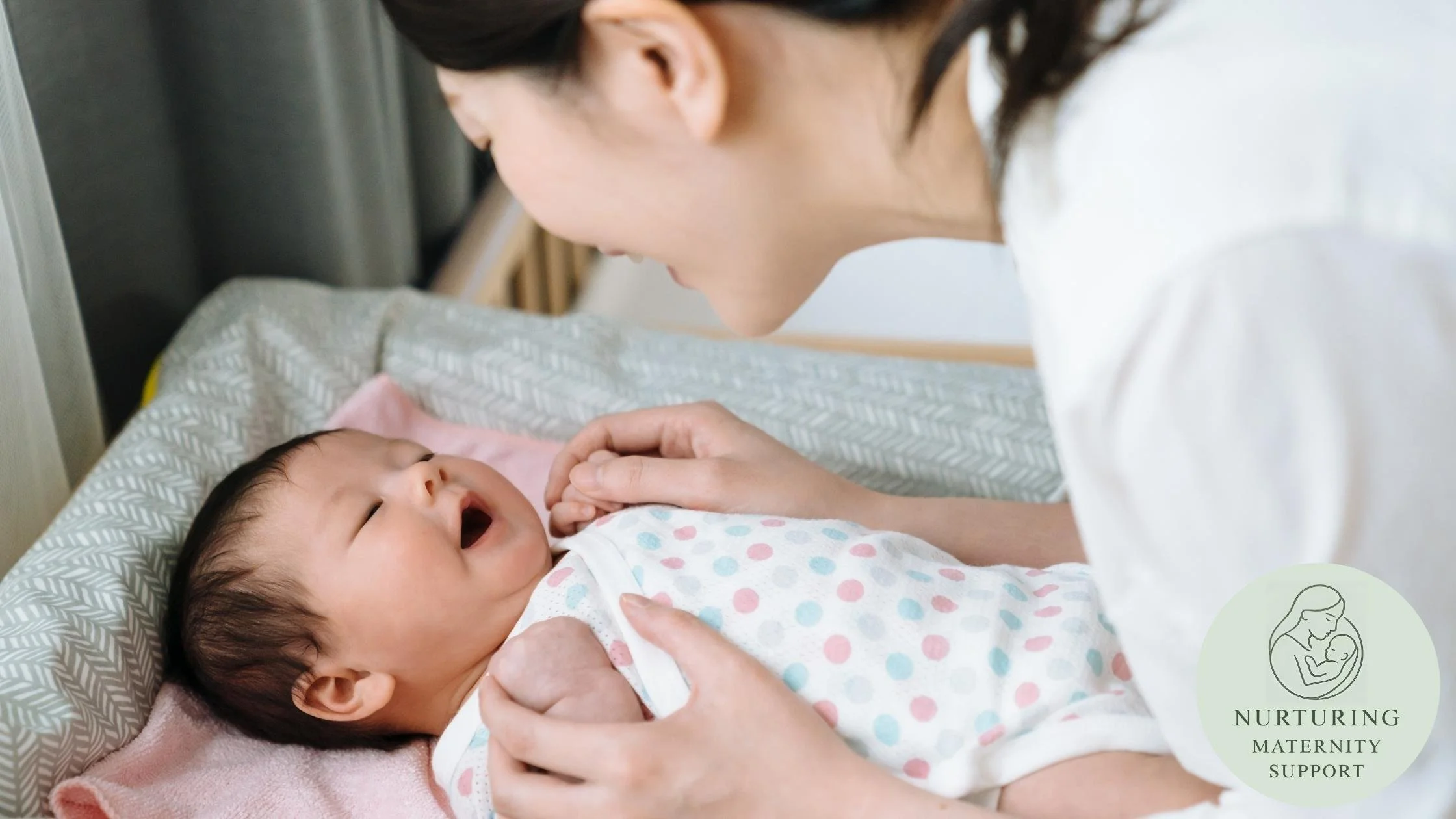 mother interacting with newborn on the changing mat