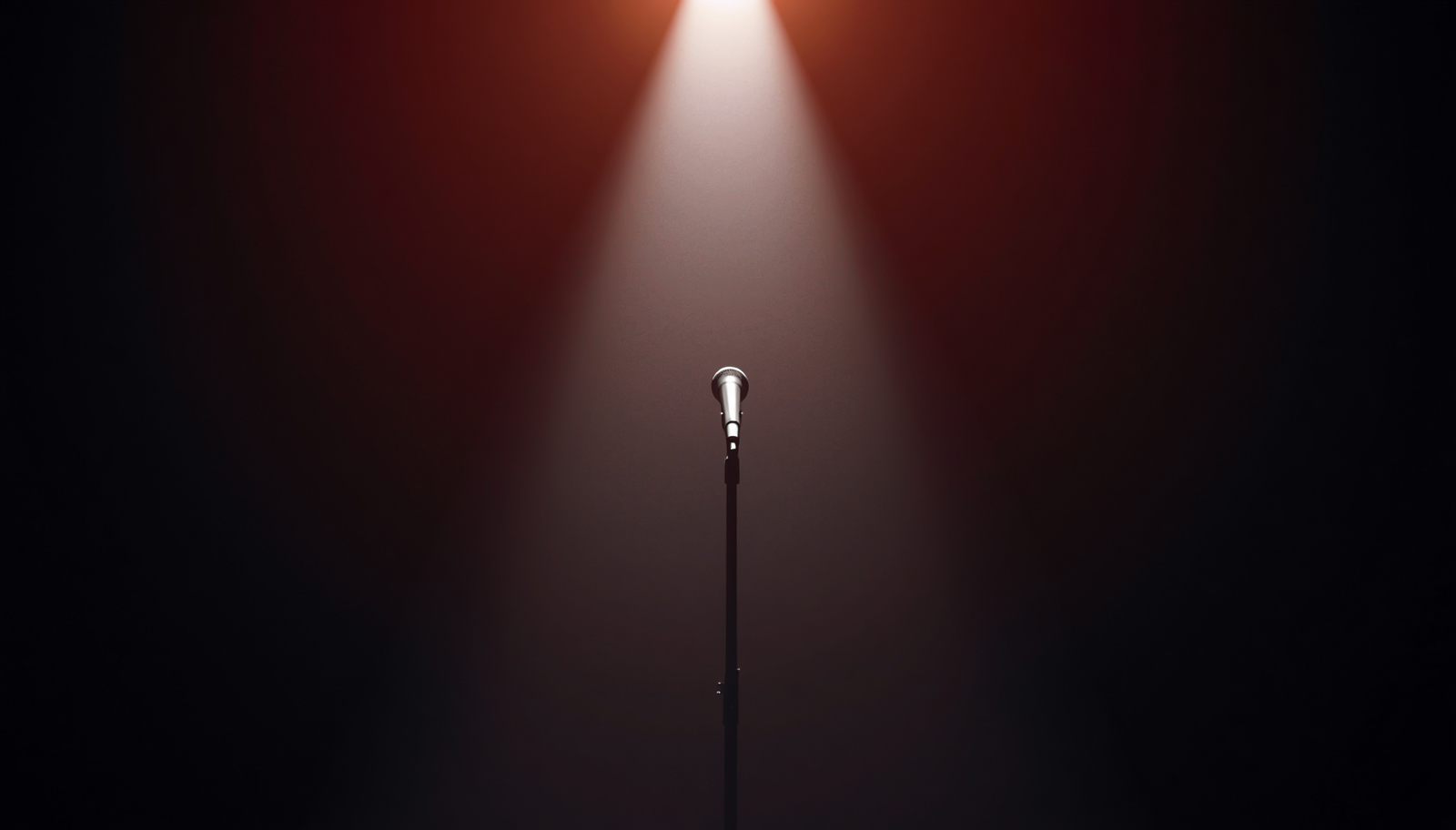 A single microphone underneath a spotlight with warm colours surrounding.jpg
