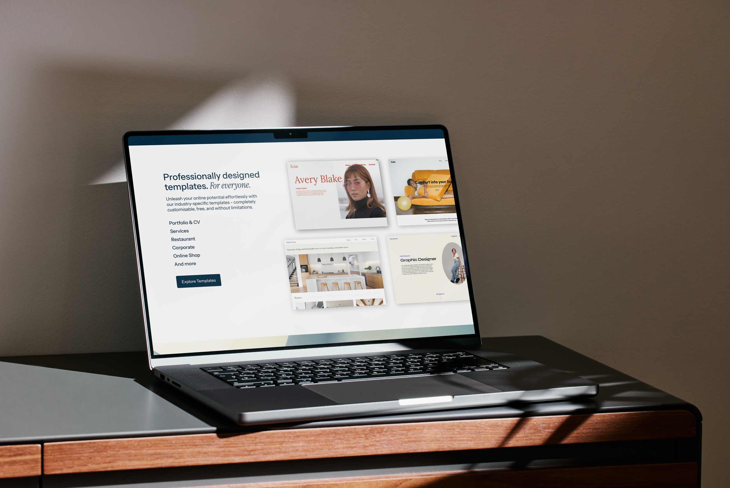 Open laptop showing a website about professionally designed templates on a wooden desk with gray surface, illuminated by sunlight