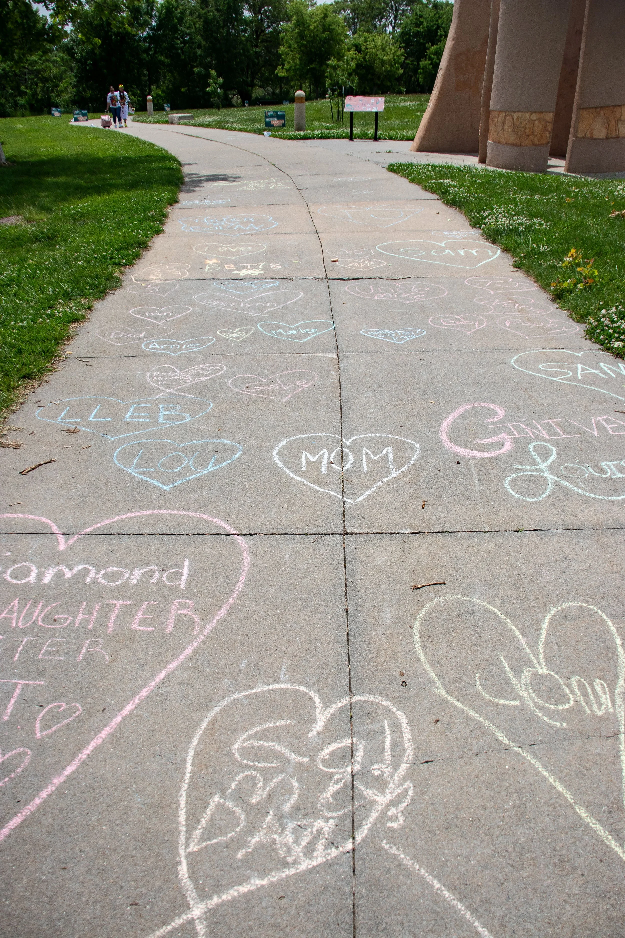 Names written in chalk on sidewalk