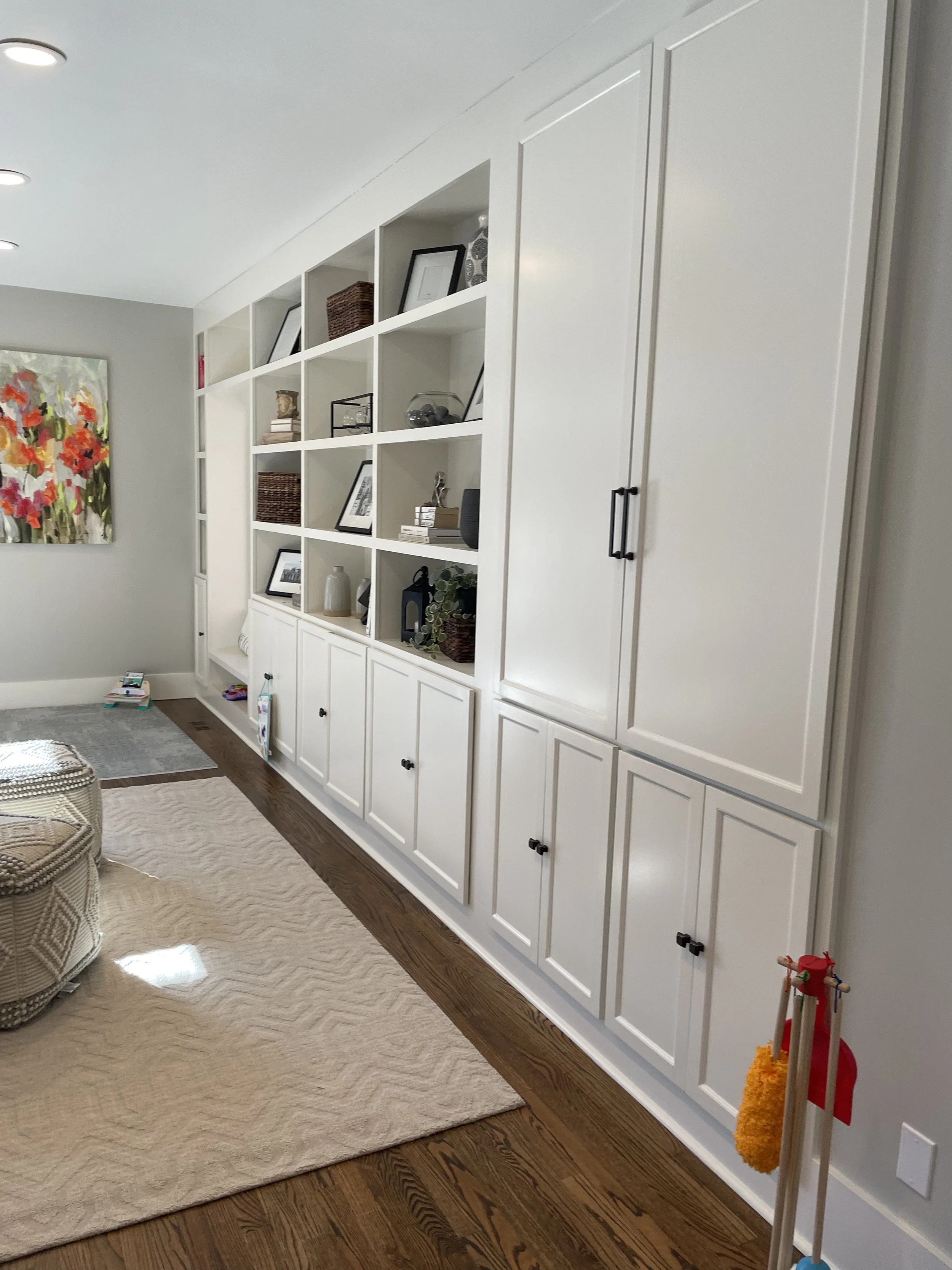 Bookcase with open shelving sections and doors to hide additional shelves.