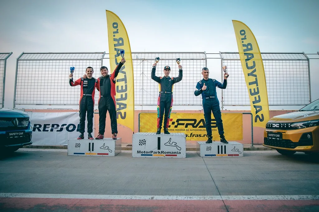 David Nicolaie celebrating on the podium after a race at MotorPark Romania, holding his trophy with a calm smile