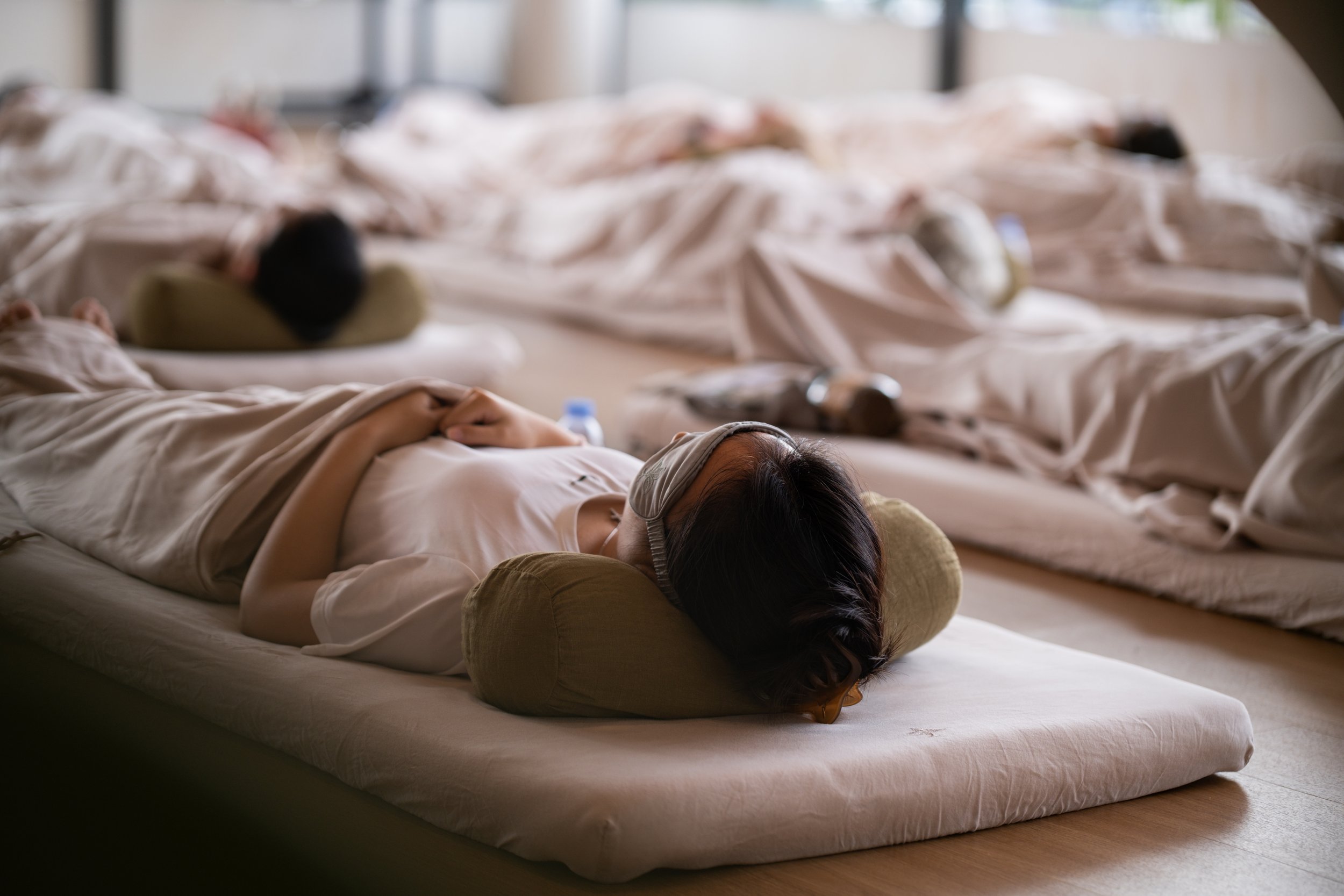 Corporate wellness program teaching Yoga Nidra for deep rest and mental health