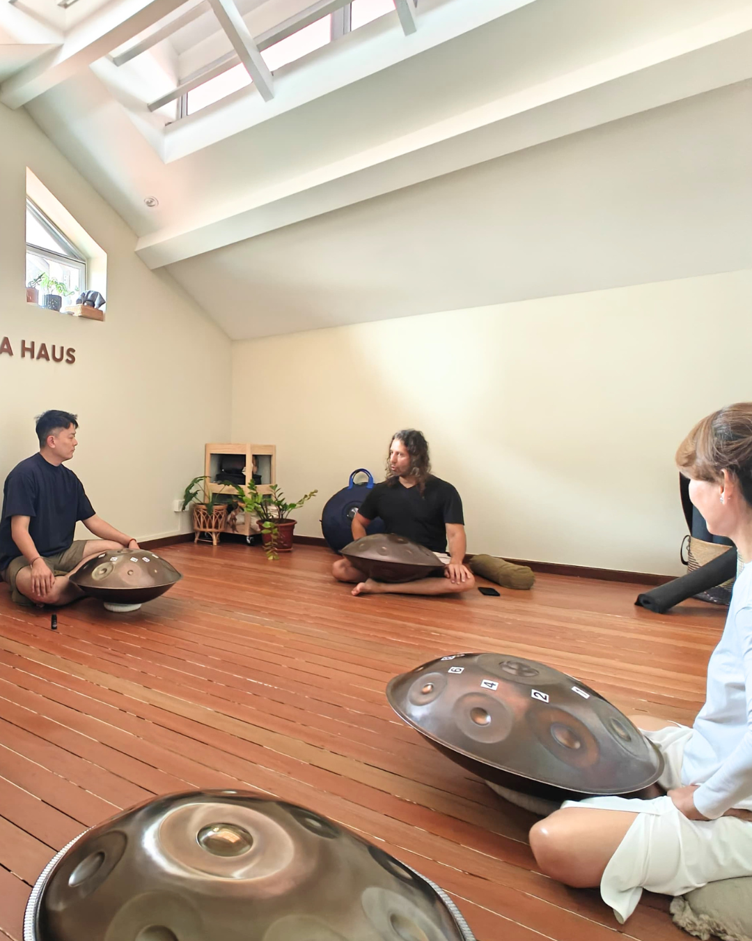 Participants seated with handpans during a handpan training for yoga and meditation at Soma Haus Joo Chiat, Singapore