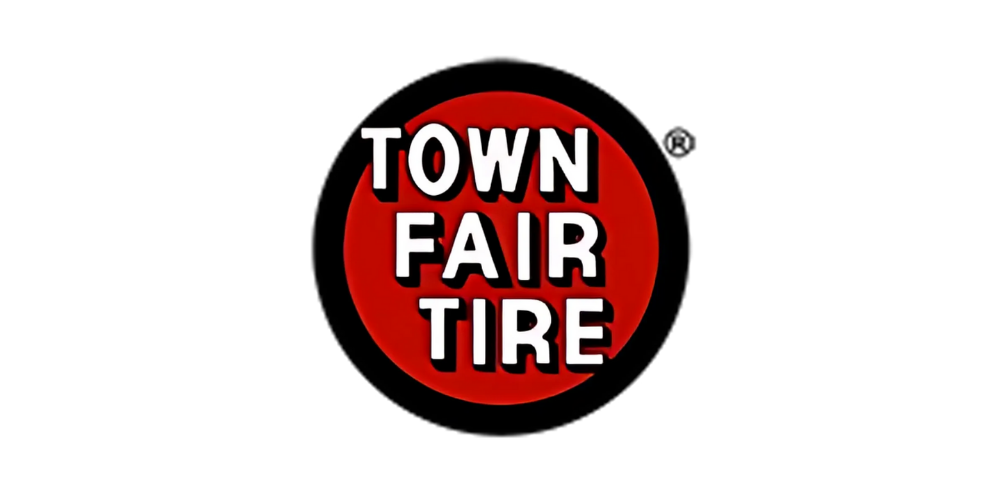Logo for Town Fair Tire with a red circle and black border, featuring the company name in white bold letters.