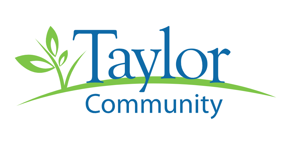 Logo for Taylor Community featuring green leaves and grass with blue text.
