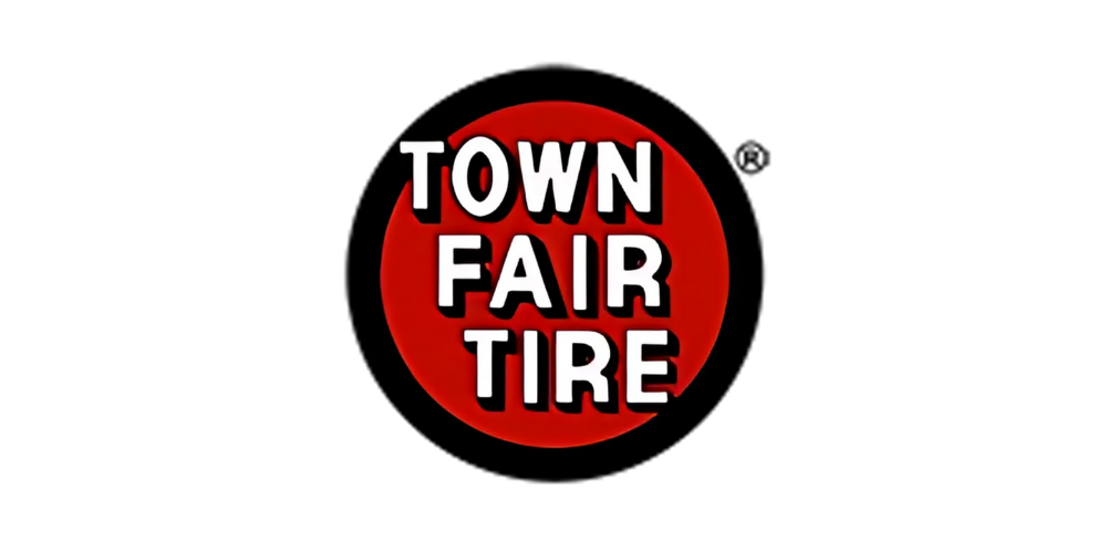 A red circle with the words "Town Fair Tire" in white and black lettering inside it.