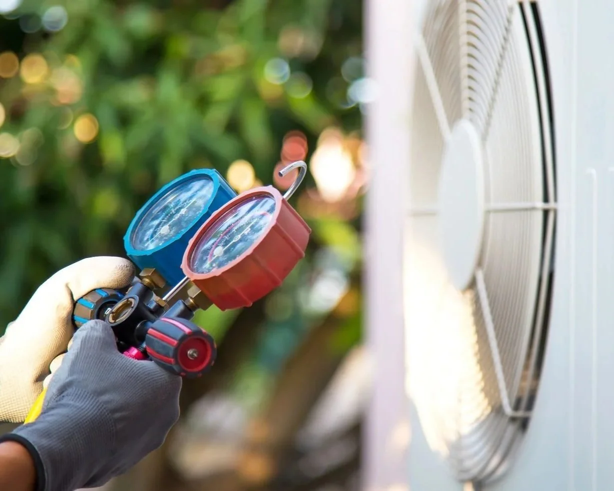 Commercial HVAC technician troubleshooting rooftop equipment