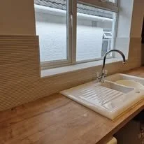 Bamboo effect kitchen wall tiles installed in a modern Hampshire kitchen, featuring natural wood-style texture with a clean contemporary finish by professional tilers near Southampton.