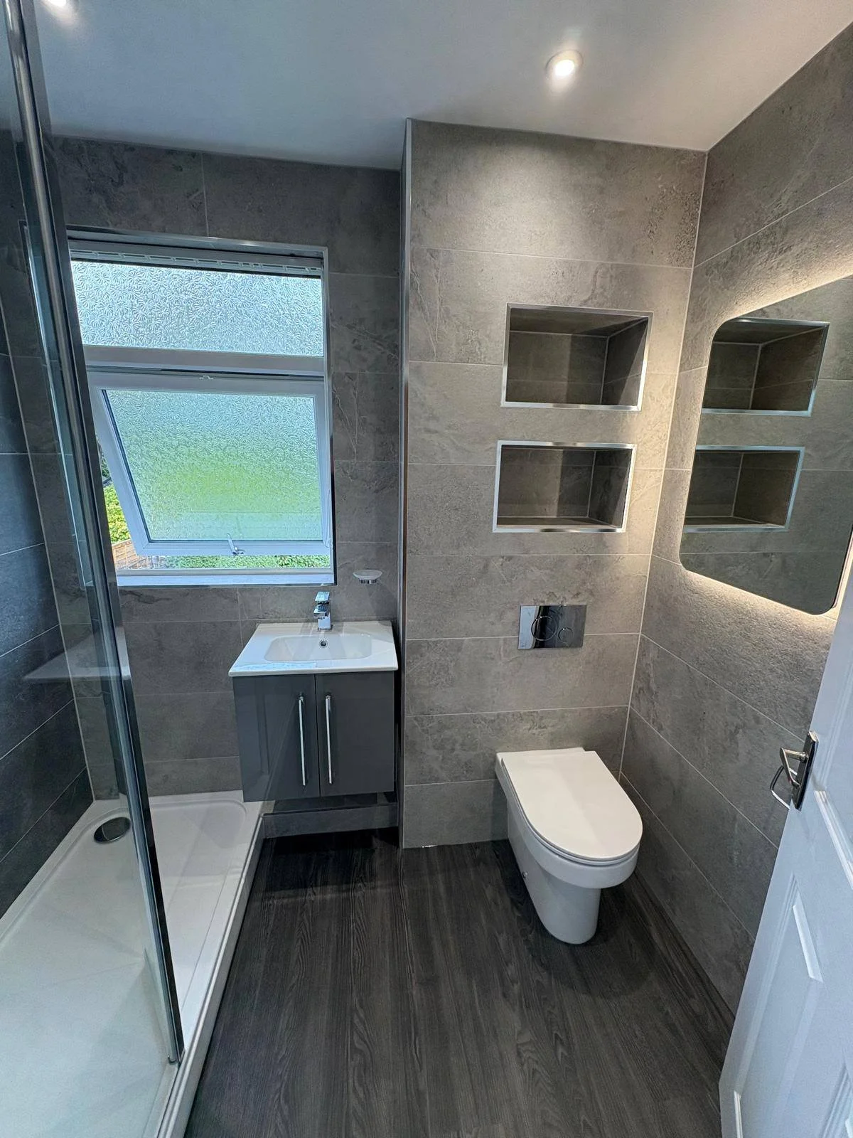 bathroom renovation showcasing newly tiled walls and floors, completely transforming the space in a southampton Hampshire home.