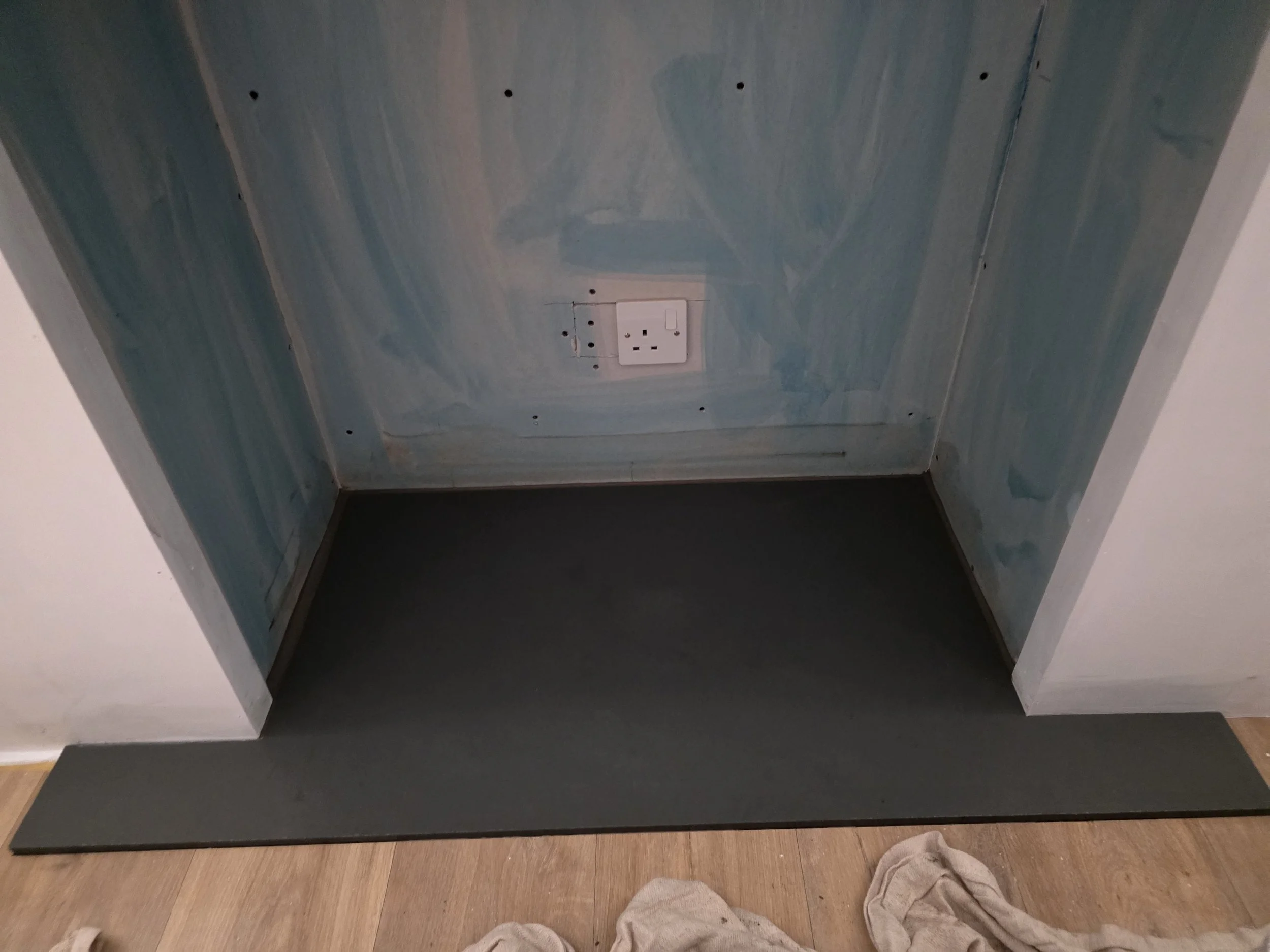 Herringbone layout paired with a slate hearth creates a striking and durable fireplace feature.