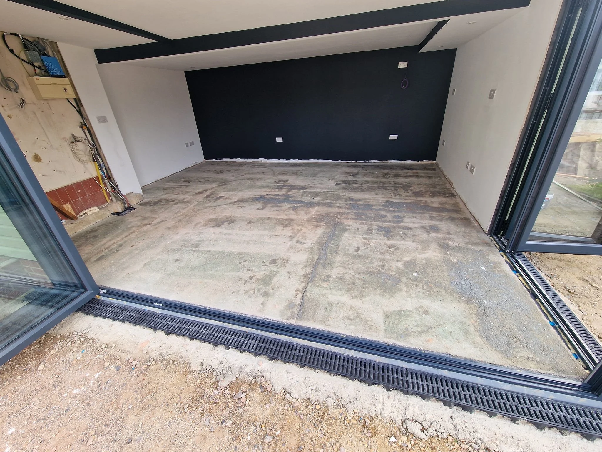 Before and after garden room transformation in West End, Hampshire, featuring large format cream porcelain floor tiles installed over uncoupling matting for a long-lasting finish.