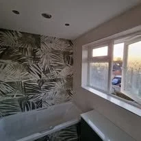 Quirky statement bathroom tiles featuring bold patterns and unique designs, expertly installed to create a standout feature in a Hampshire home.