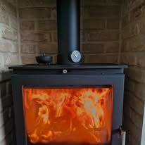 Brick slips and a solid granite hearth provide a timeless, heat-resistant finish for this log burner. southampton tile infinity