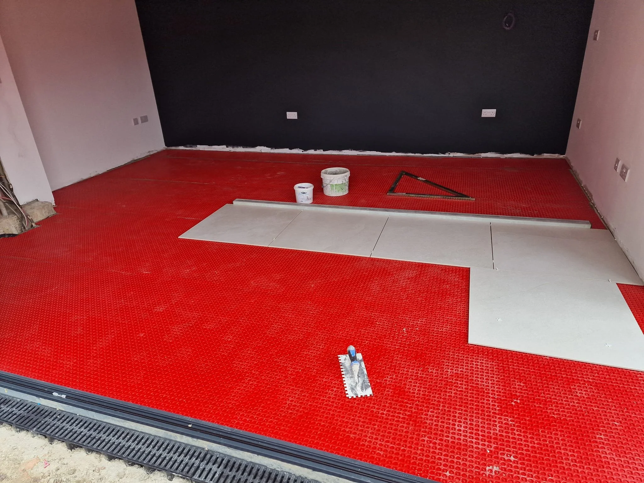 Before and after garden room transformation in West End, Hampshire, featuring large format cream porcelain floor tiles installed over uncoupling matting for a long-lasting finish.