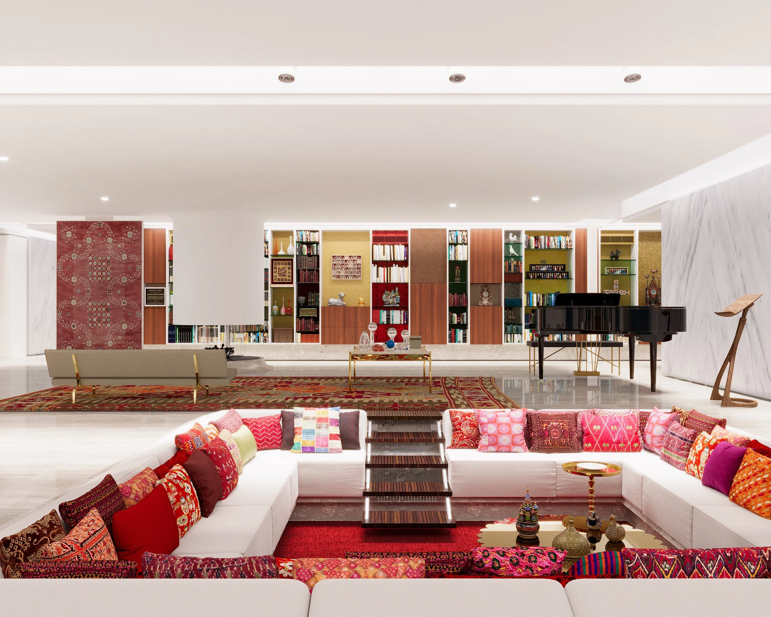 Living room with white sectional sofa decorated with colorful patterned pillows, wooden staircase, collection of books and decorative items on wooden shelves, grand black piano, marble wall, and a colorful rug.