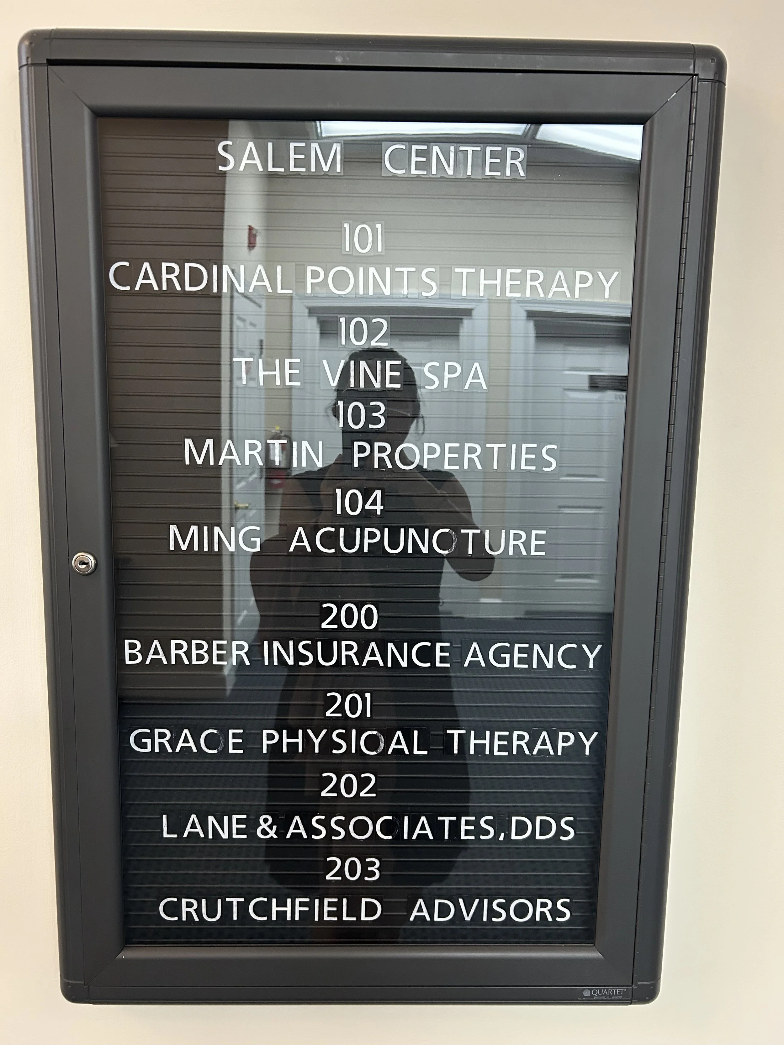 Directory board listing various offices and services including Salem Center, Cardinal Points Therapy, The Vine Spa, Martin Properties, Ming Acupuncture, Barber Insurance Agency, Grace Physical Therapy, Lane & Associates DDS, and Crutchfield Advisors.