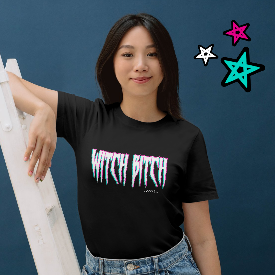 Woman in black t-shirt with "Witch Bitch" text, standing next to a white ladder, blue background with colorful star illustrations.