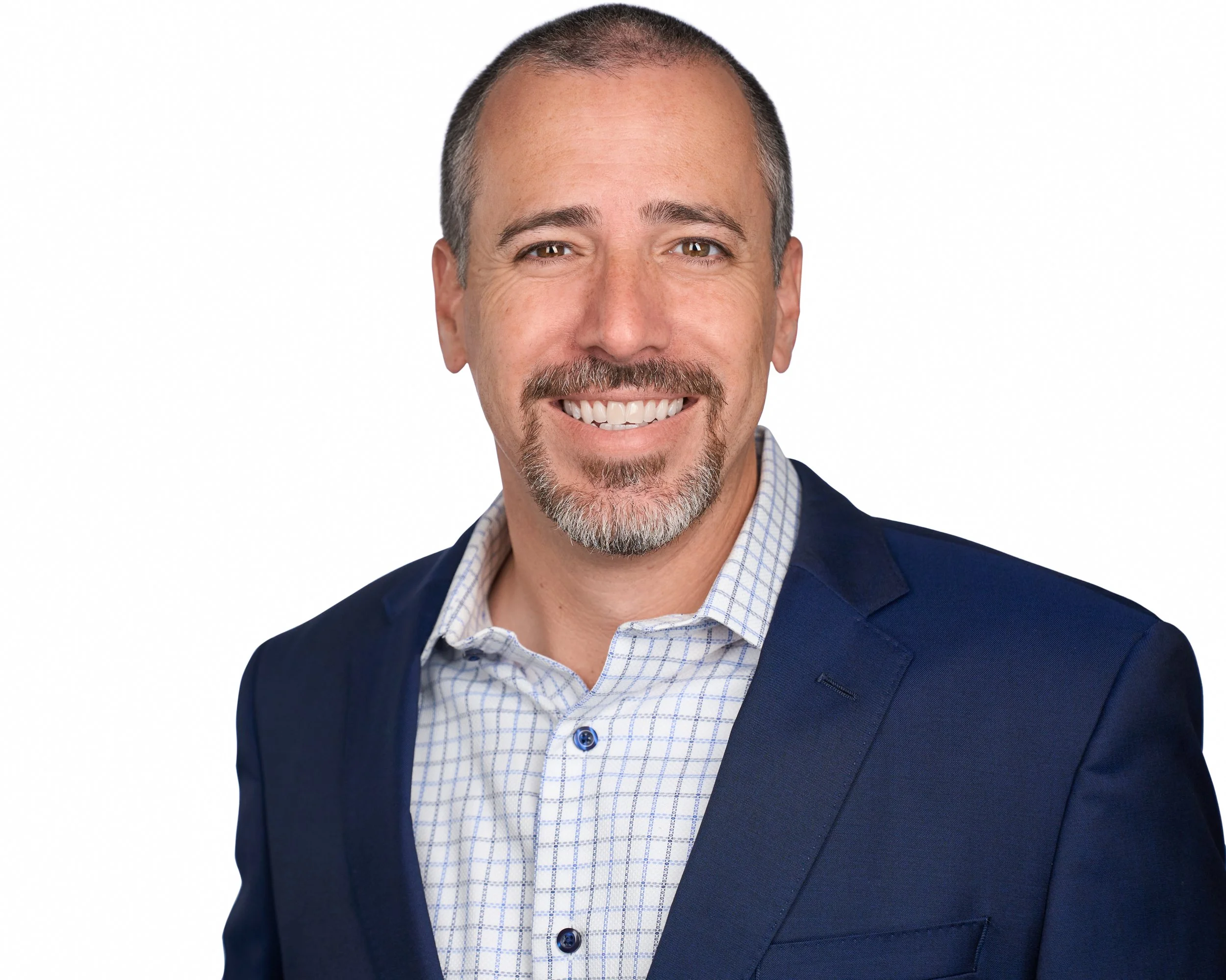 A headshot of a middle-aged man with short hair, a goatee, wearing a navy suit jacket over a white checkered shirt, smiling at the camera against a plain white background.