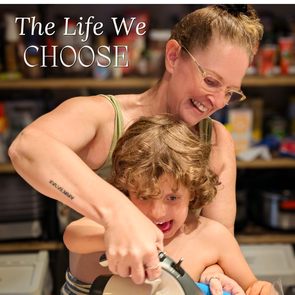 A laughing woman and child at a kitchen bench together. Text: "The Life We CHOOSE".