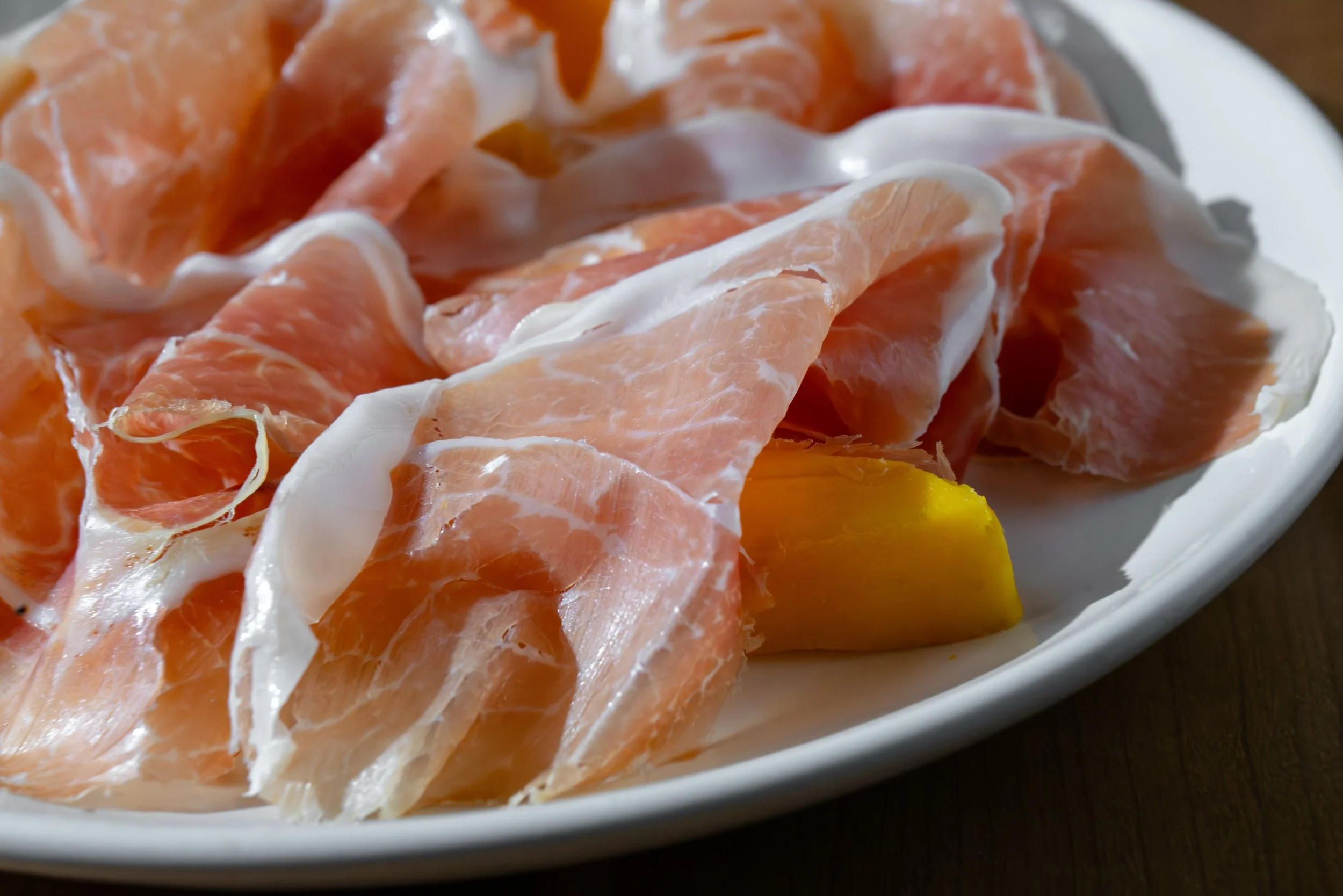 We update our spin on prosciutto-wrapped melon seasonally. Often it's with mango (a nod to Louie herself's Filipino heritage) but right now you can come try the dish with plumcot (a hybrid of plum and apricot) and, as always American heritage prosciu