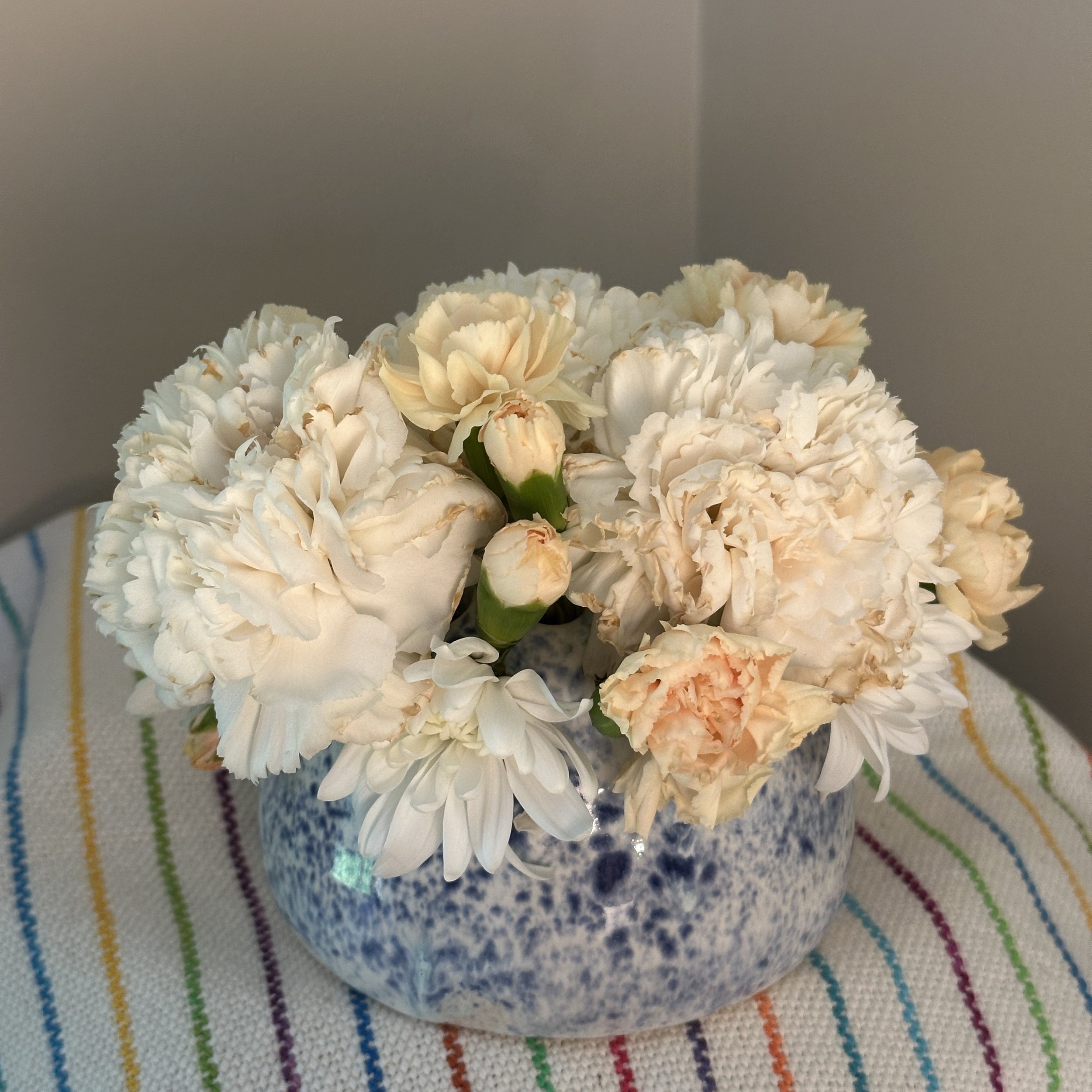 Small speckled blue vase top with flowers