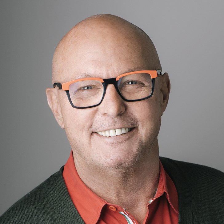 Bald man with glasses smiling